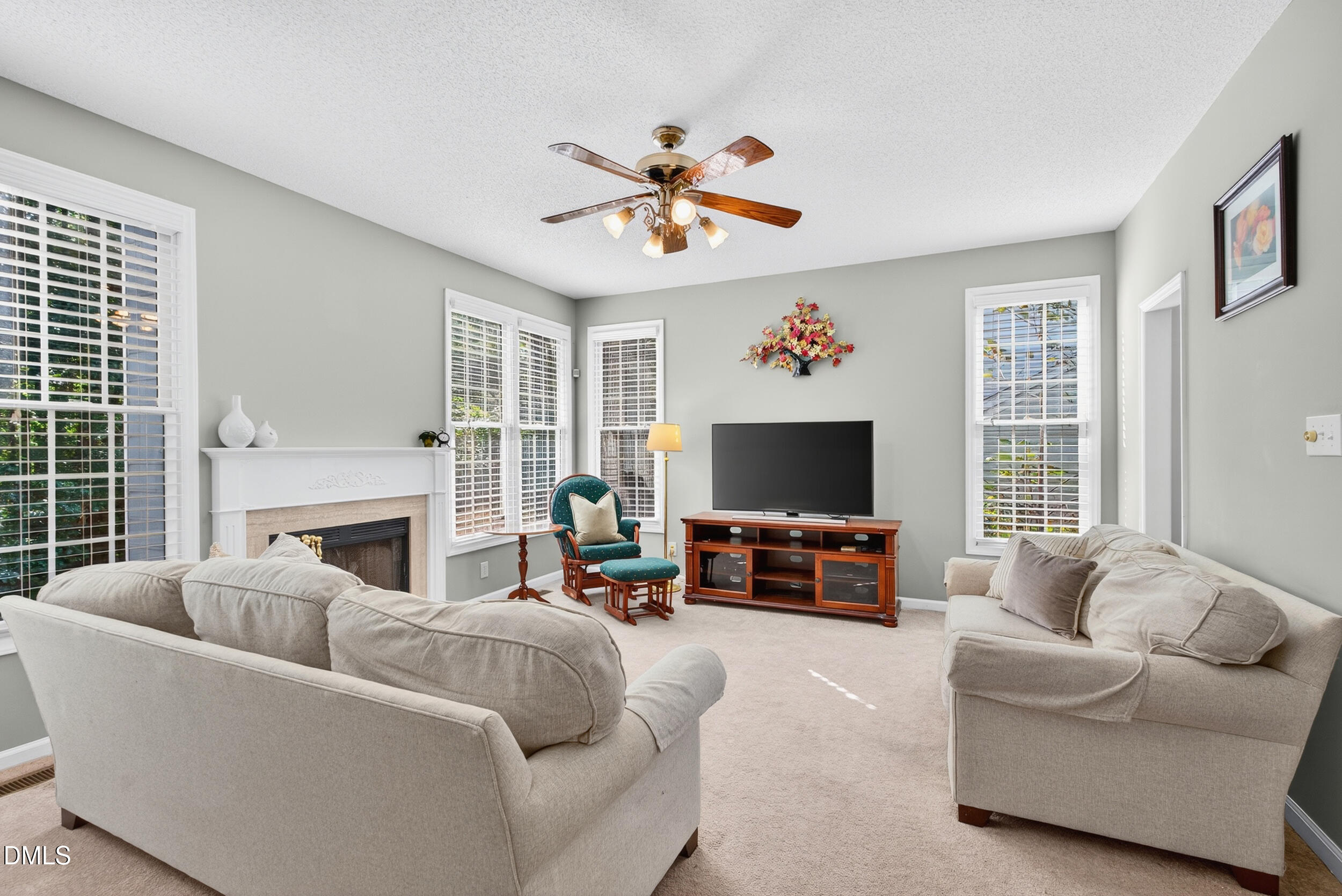 105 Point Harbor Drive Cary, NC 27519 - Photo 12 of 39 a living room with furniture a fireplace and a flat screen tv