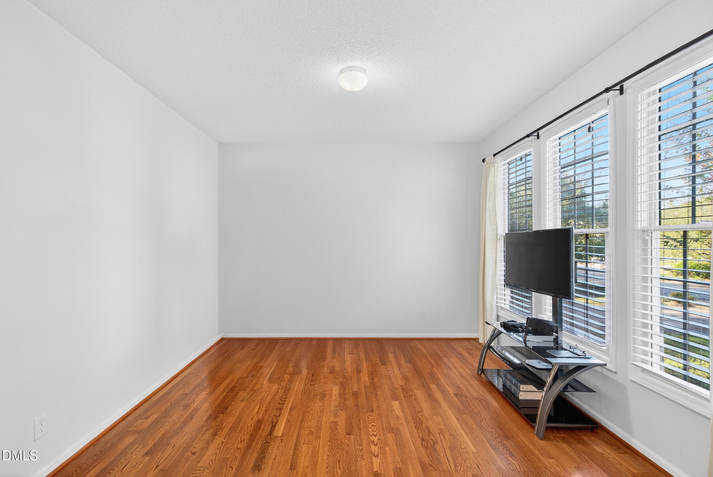 105 Point Harbor Drive Cary, NC 27519 - Photo 17 of 39 a view of a workspace with wooden floor and a window