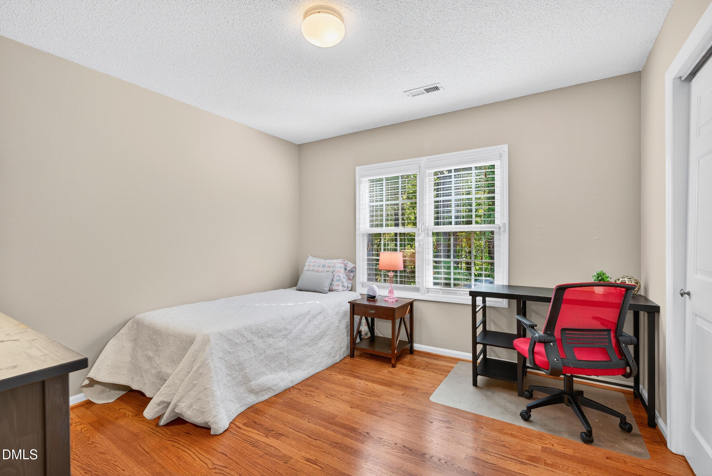 105 Point Harbor Drive Cary, NC 27519 - Photo 26 of 39 a bedroom with a bed chair and a window