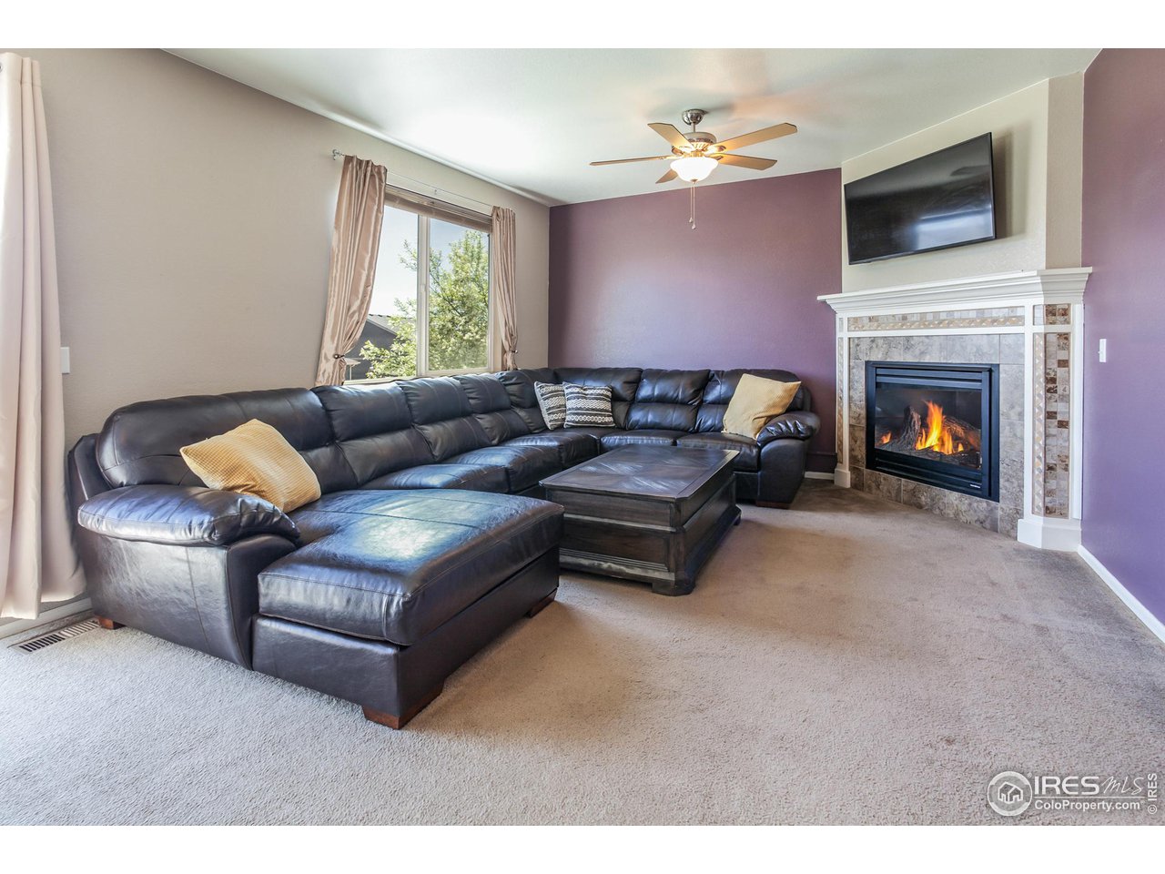 8594 Raspberry Drive Frederick, CO 80504 - Photo 15 of 40 a living room with furniture and a fireplace