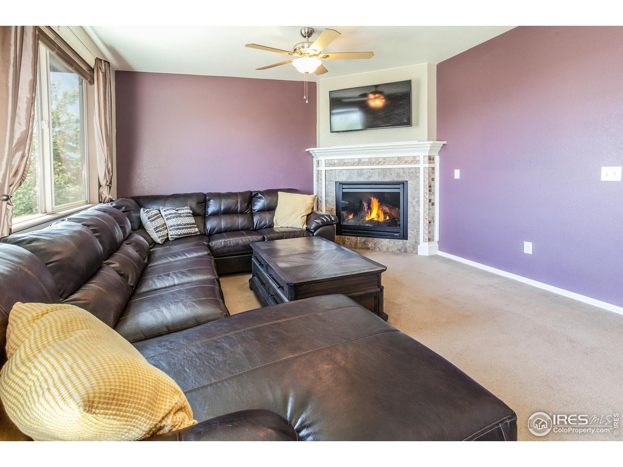 8594 Raspberry Drive Frederick, CO 80504 - Photo 16 of 40 a living room with furniture and a fireplace