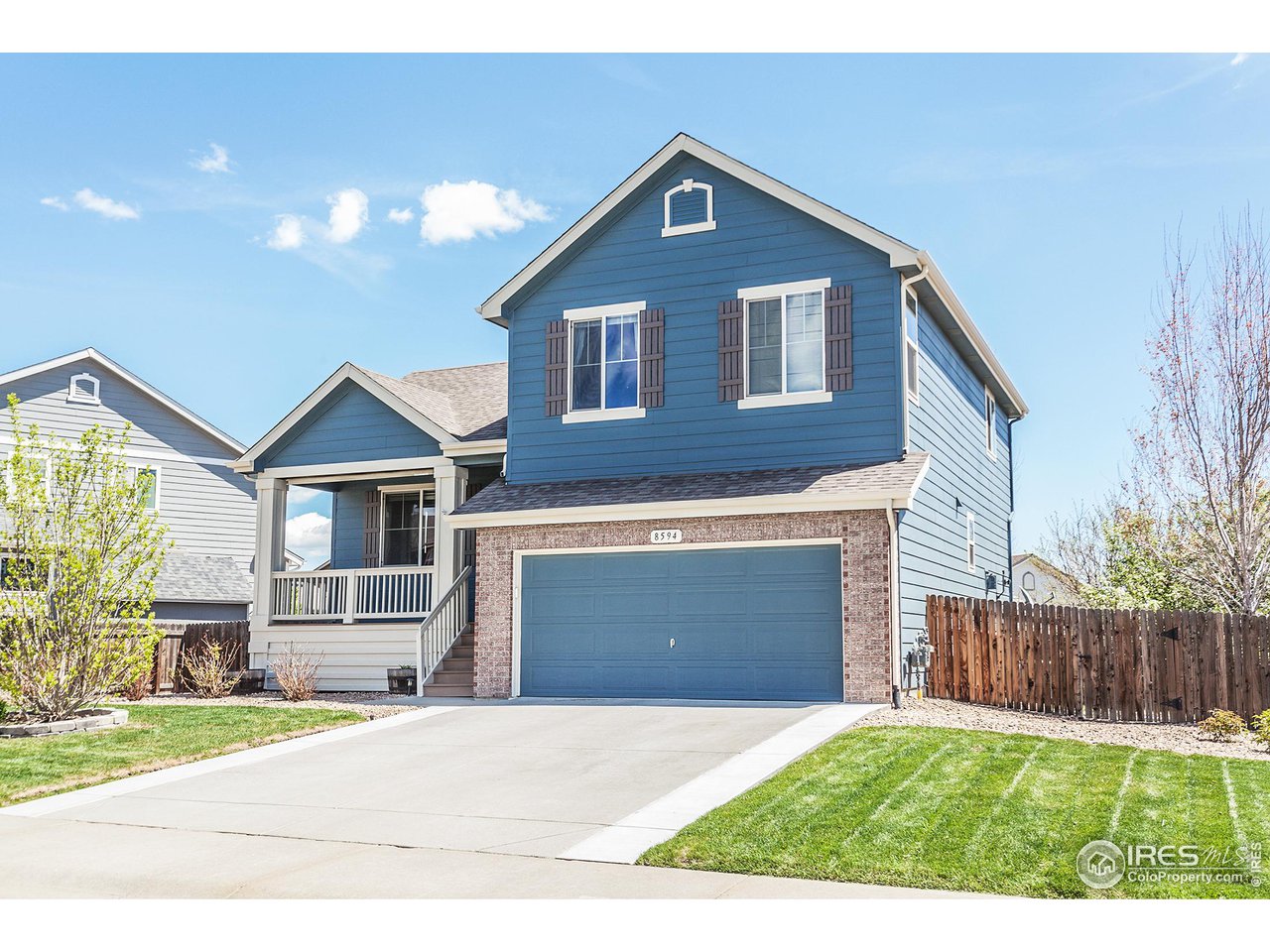8594 Raspberry Drive Frederick, CO 80504 - Photo 2 of 40 a front view of a house with a yard and garage
