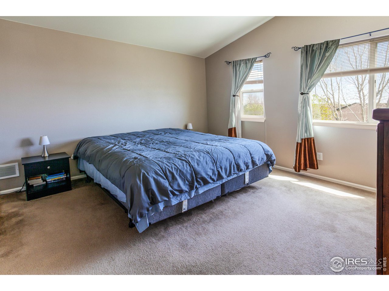 8594 Raspberry Drive Frederick, CO 80504 - Photo 23 of 40 a spacious bedroom with a bed and a window