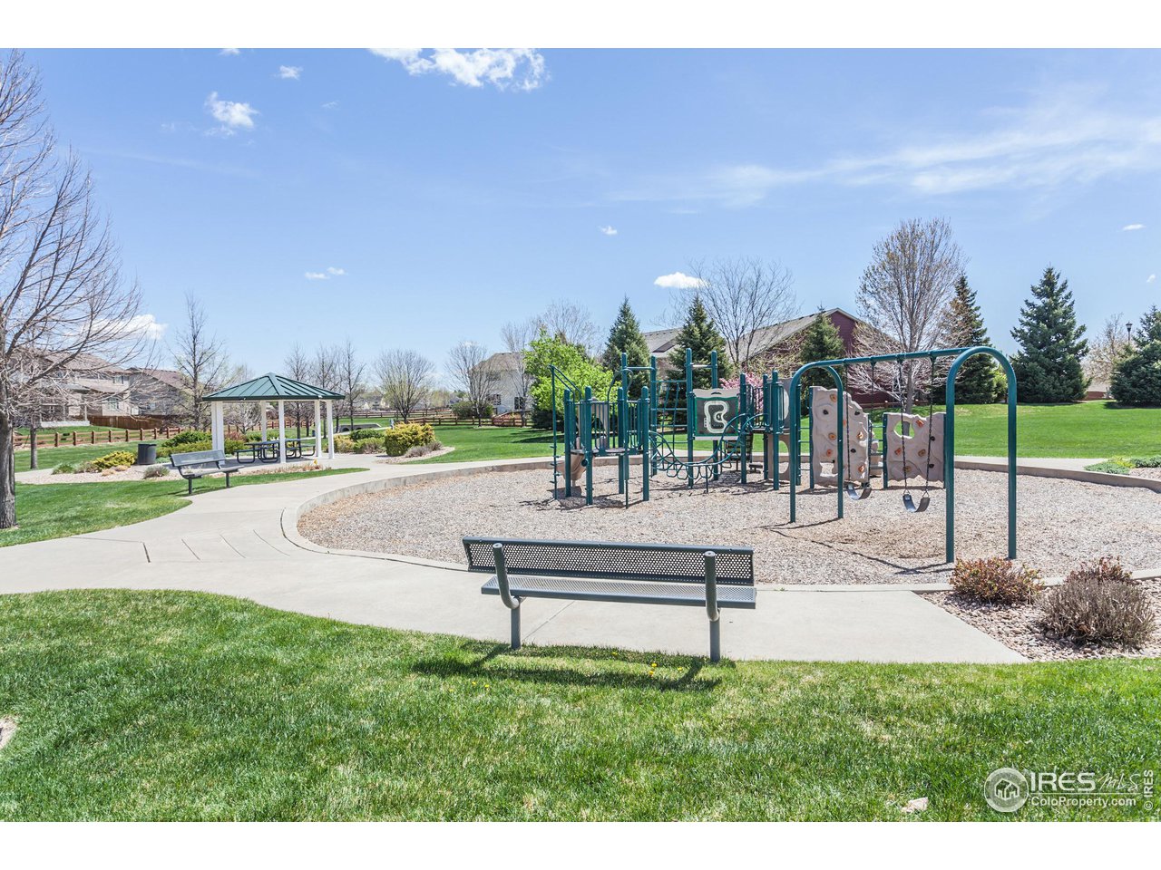 8594 Raspberry Drive Frederick, CO 80504 - Photo 39 of 40 a park view with a bench