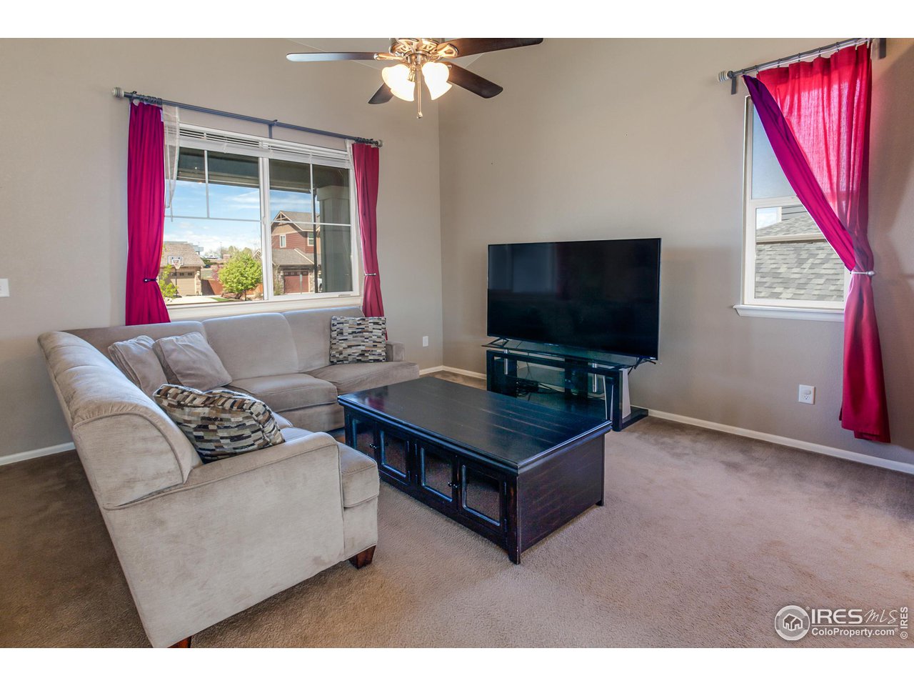 8594 Raspberry Drive Frederick, CO 80504 - Photo 6 of 40 a living room with furniture and a flat screen tv