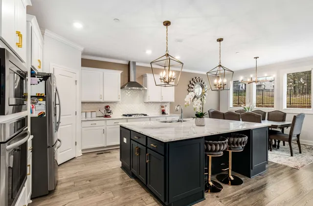 a spacious bedroom with a bed and a chandelier