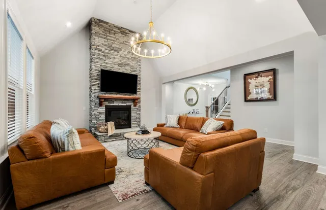 a kitchen with a stove a sink a dining table and chairs