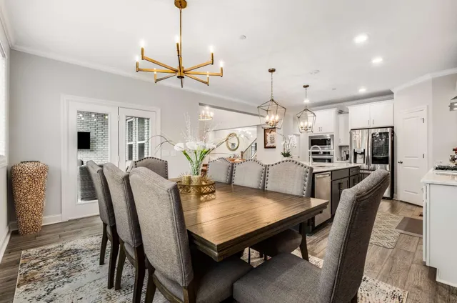 a kitchen with stainless steel appliances granite countertop a sink a stove and a wooden floors