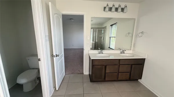 a bathroom with a sink vanity and toilet