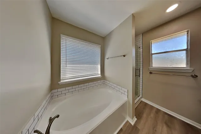 a bathroom with a bathtub and a window