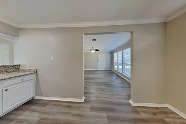 a view of hallway with wooden floor