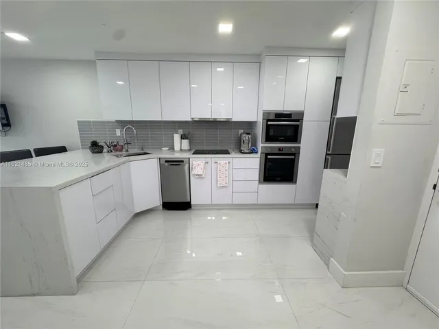 a kitchen with a sink a stove and refrigerator