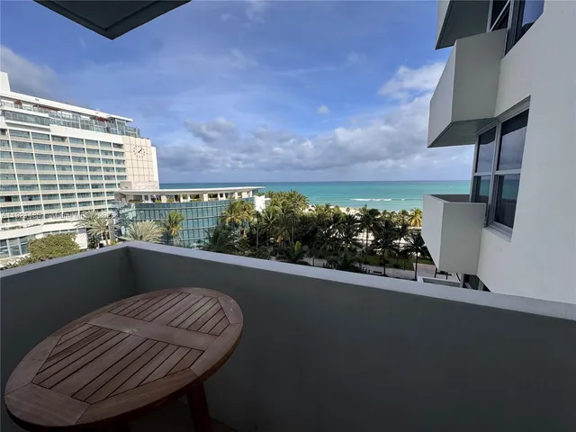 a view of a balcony with chair and a potted plant