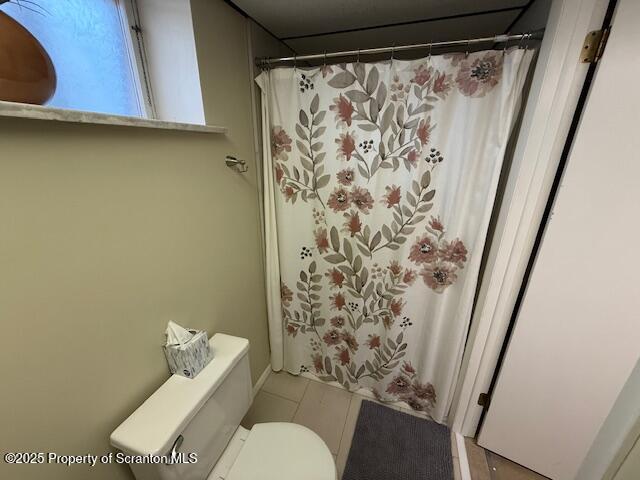 405 17th Avenue Scranton, PA 18504 - Photo 24 of 28 a white toilet sitting next to a shower curtain