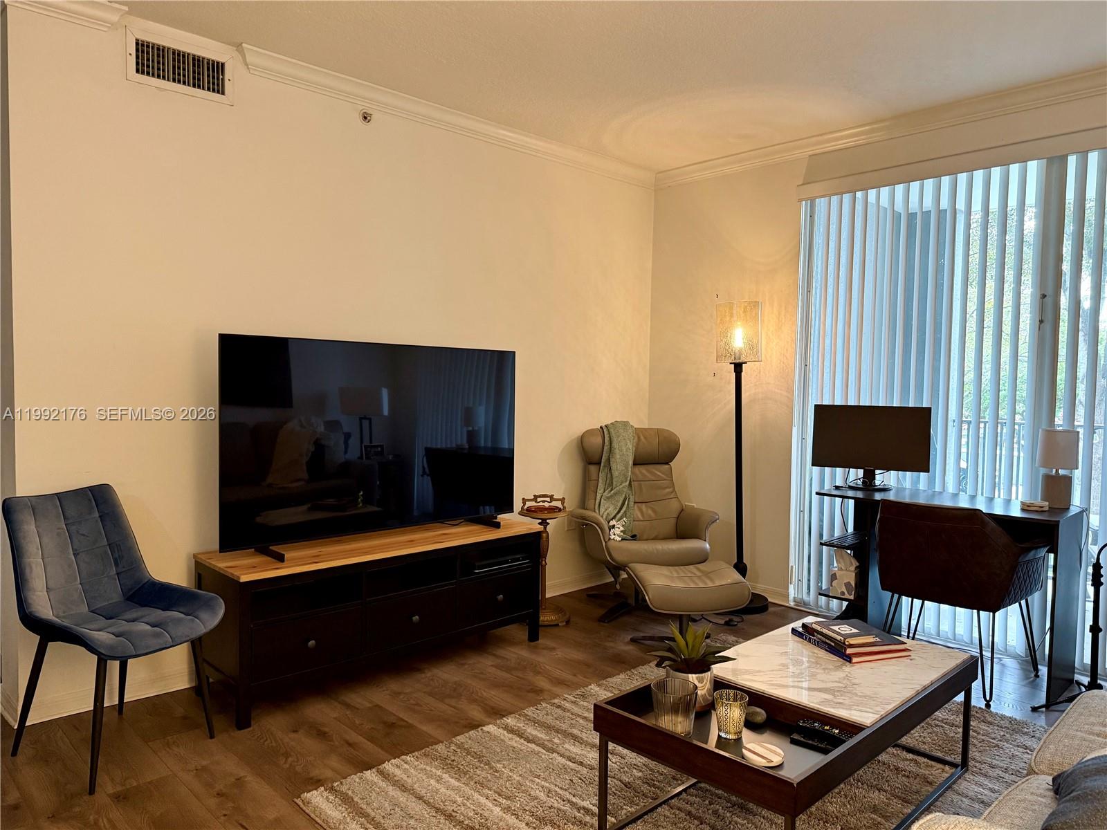 6831 Southwest 44th Street, Unit 203 Miami, FL 33155 - Photo 4 of 15 a living room with furniture and a flat screen tv