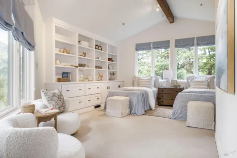 a bedroom with furniture and windows