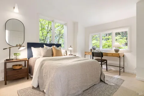 a bed room with a bed and a chair