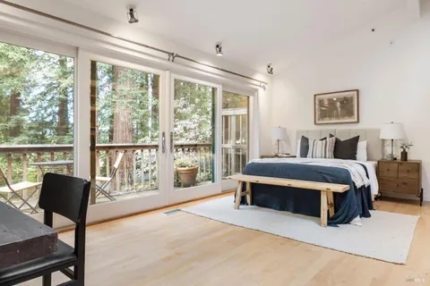 a spacious bedroom with a bed and a large window