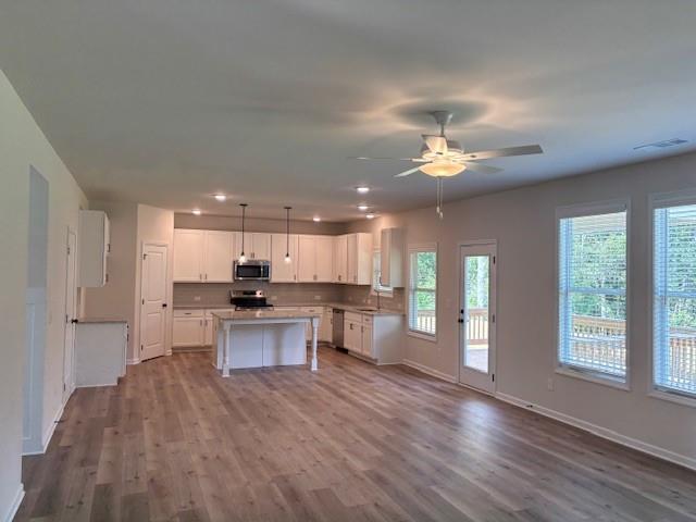 345 Rodeo Drive Auburn, GA 30011 - Photo 9 of 22 a open kitchen with white cabinets and wooden floor