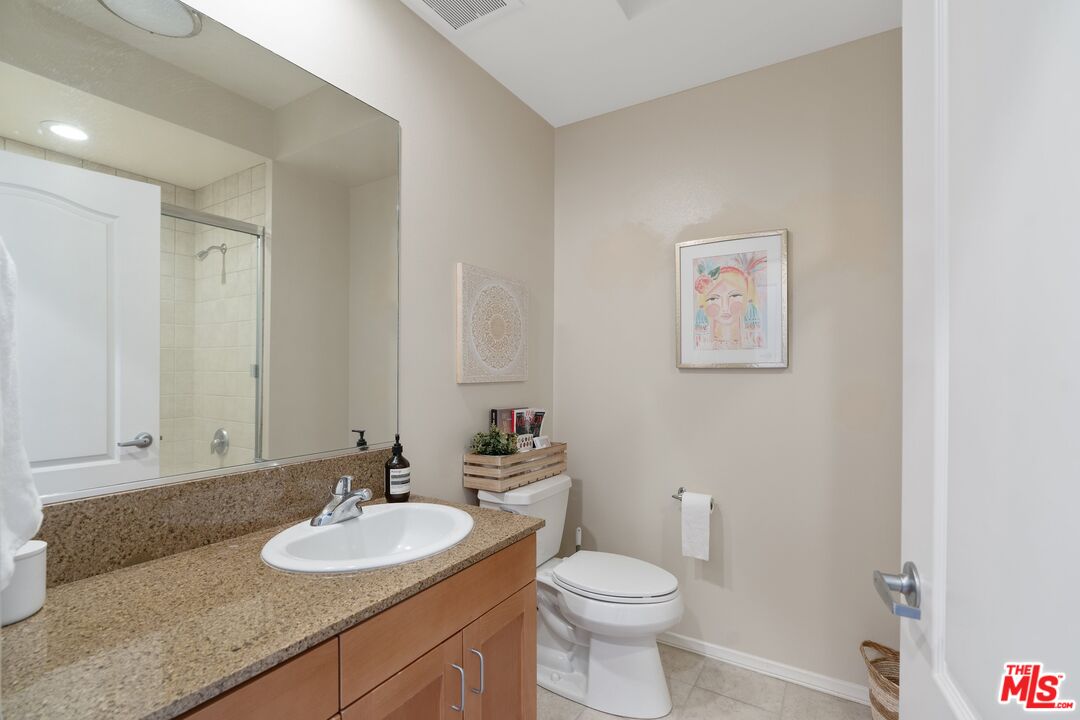 4170 Fair Avenue, Unit PH2 Studio City, CA 91602 - Photo 22 of 42 a bathroom with a granite countertop sink mirror vanity and toilet