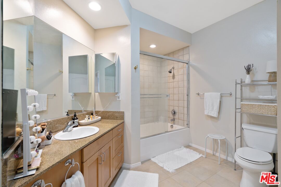 4170 Fair Avenue, Unit PH2 Studio City, CA 91602 - Photo 30 of 42 a bathroom with a granite countertop sink toilet and shower