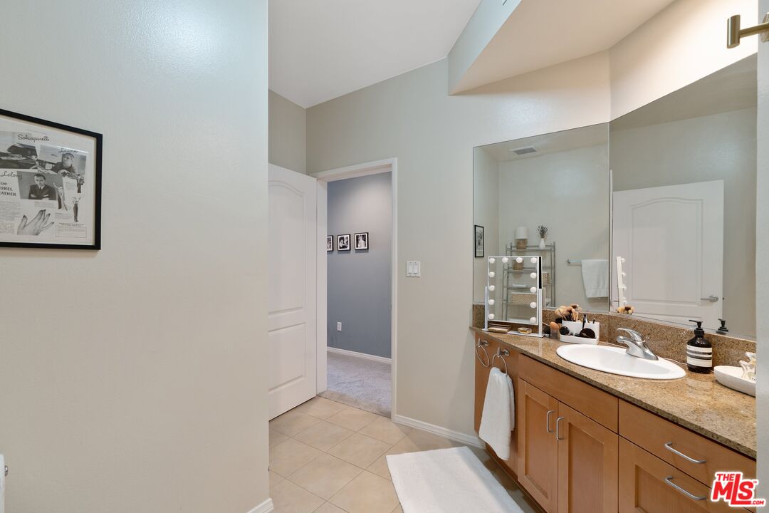 4170 Fair Avenue, Unit PH2 Studio City, CA 91602 - Photo 31 of 42 a bathroom with a granite countertop sink a mirror and a shower