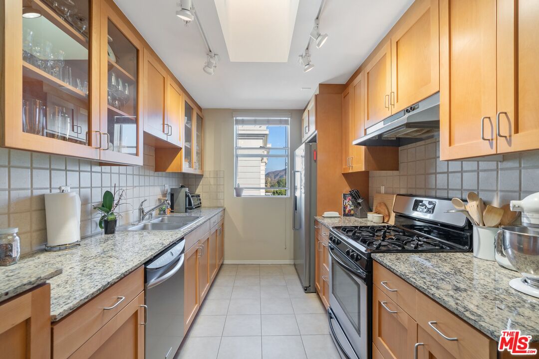 4170 Fair Avenue, Unit PH2 Studio City, CA 91602 - Photo 9 of 42 a kitchen with granite countertop a sink a counter top space and cabinets