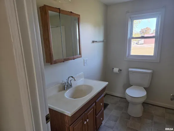 an empty room with wooden floor and a window