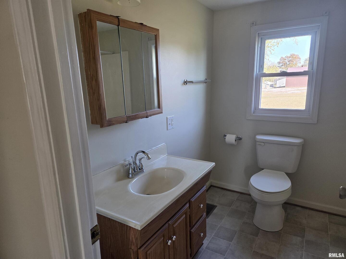 208 West Cherry Street Springerton, IL 62887 - Photo 11 of 13 a bathroom with a sink toilet and a mirror