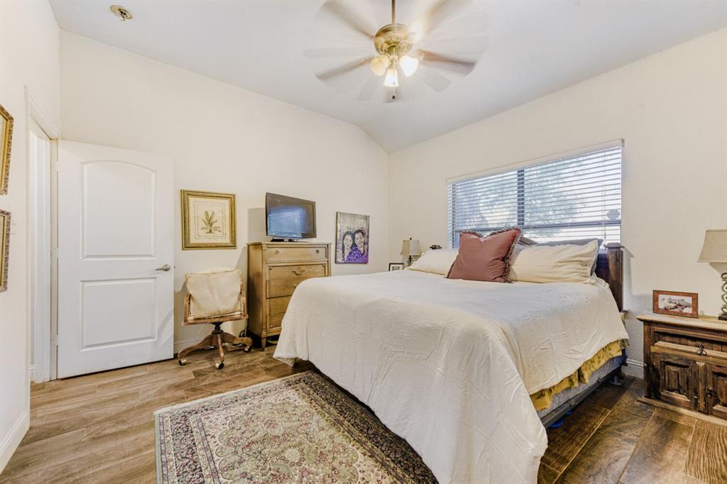 6525 Greenway Road Fort Worth, TX 76116 - Photo 10 of 29 a bedroom with a bed and a chandelier