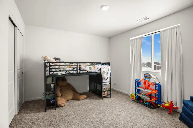 a utility room with dryer and baby crib