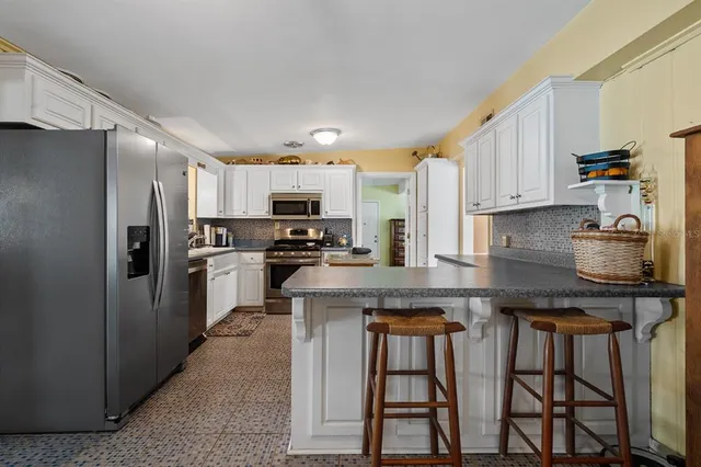 a living room with furniture a ceiling fan and a rug