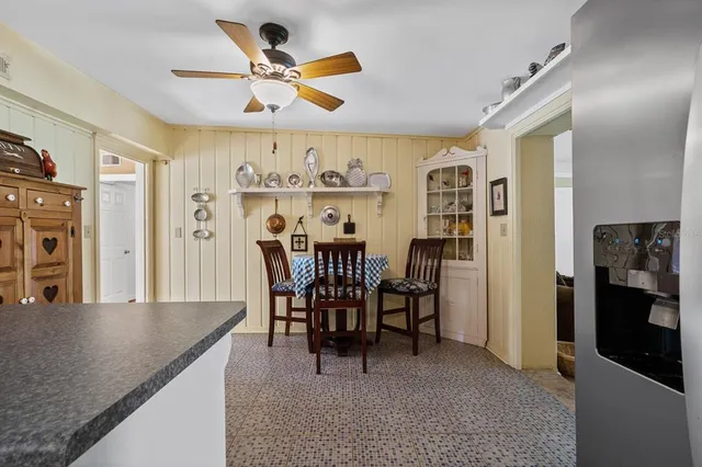 a living room with furniture a ceiling fan and a rug
