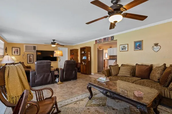 a living room with furniture and a chandelier
