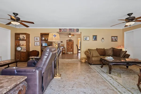 a bedroom with a bed a chandelier and a dresser