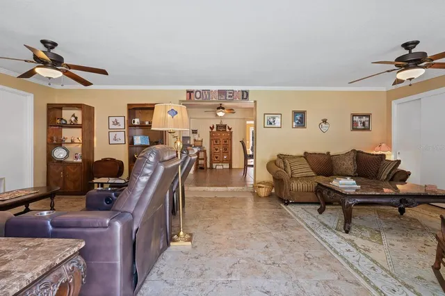 a bedroom with a bed a chandelier and a dresser