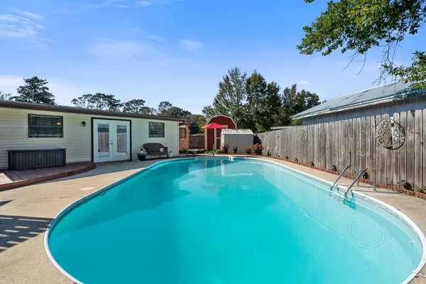 a front view of a house with a yard and trees