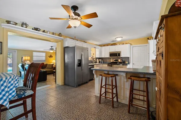 a kitchen with stainless steel appliances granite countertop a refrigerator a stove top oven a sink and dishwasher