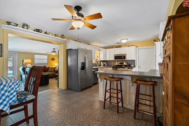 a kitchen with stainless steel appliances granite countertop a refrigerator a stove top oven a sink and dishwasher