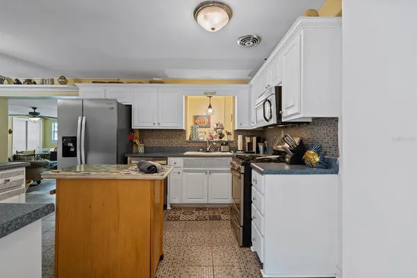a kitchen with a stove and a cabinets
