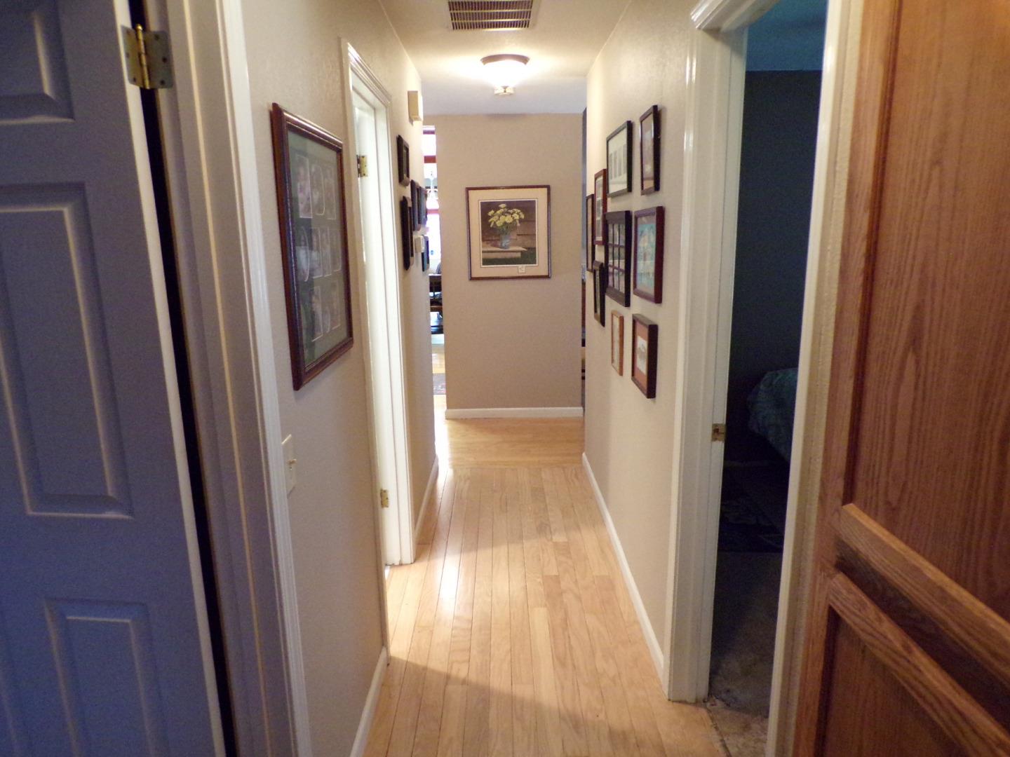 7674 Benassi Drive Gilroy, CA 95020 - Photo 15 of 16 a view of a hallway with wooden floor and a bathroom