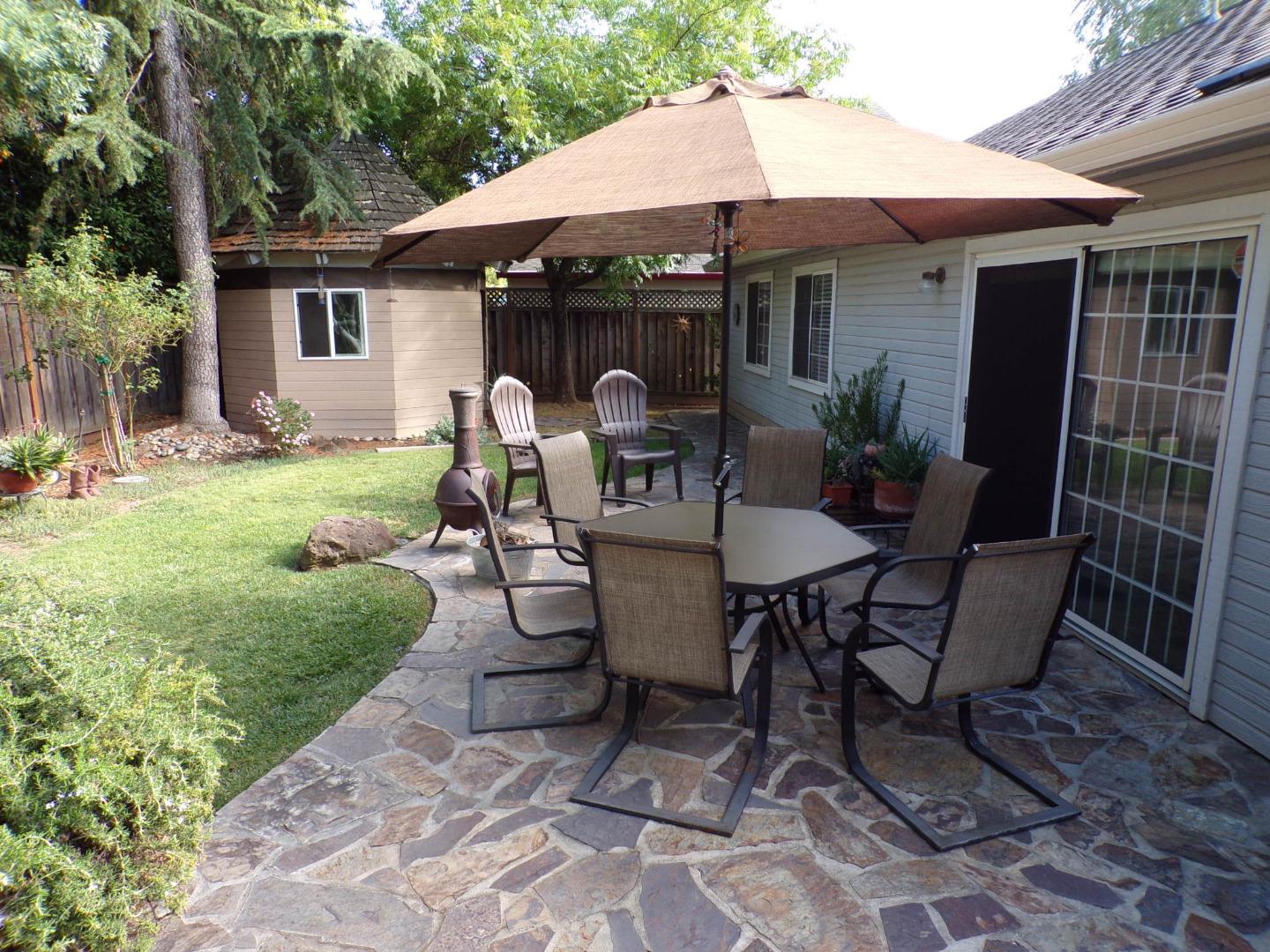 7674 Benassi Drive Gilroy, CA 95020 - Photo 3 of 16 a view of a patio with a table chairs and a yard