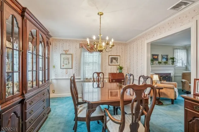 a view of a dining room with furniture and chandelier