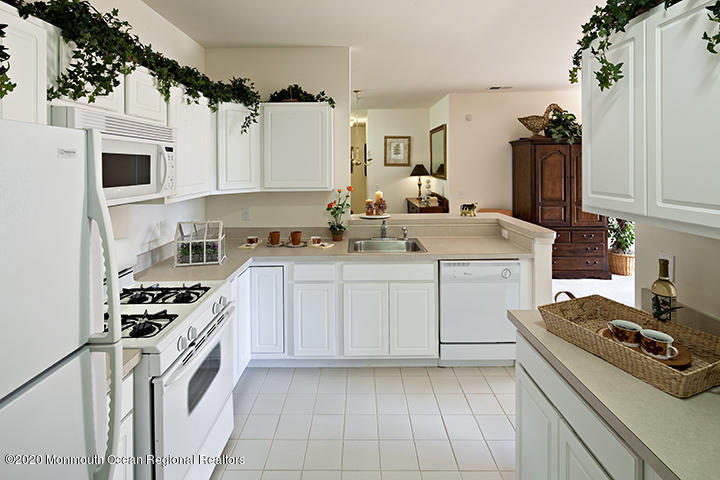 714 Timber Ridge Court Neptune Township, NJ 07753 - Photo 11 of 15 a kitchen with a sink stove and cabinets