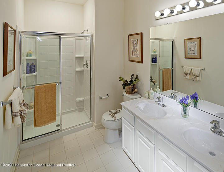 714 Timber Ridge Court Neptune Township, NJ 07753 - Photo 12 of 15 a bathroom with a double vanity sink toilet and shower