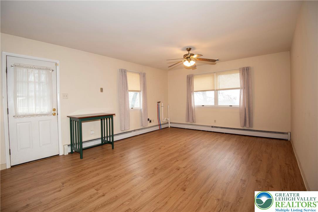 844 Weil Street Bethlehem, PA 18015 - Photo 2 of 19 an empty room with wooden floor and windows