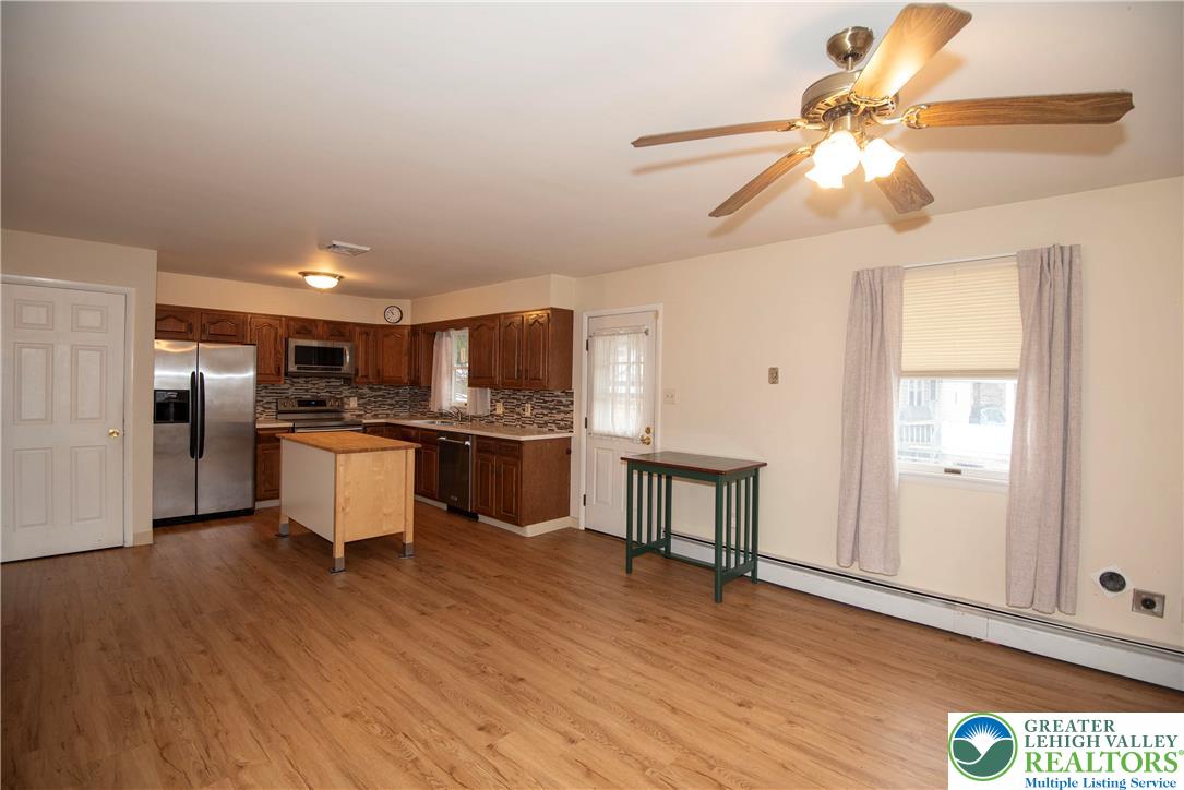 844 Weil Street Bethlehem, PA 18015 - Photo 8 of 19 a kitchen with stainless steel appliances kitchen island granite countertop a refrigerator a stove a sink dishwasher and white cabinets with wooden floor