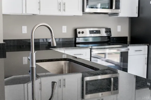 a close view of a stove top oven and cabinets