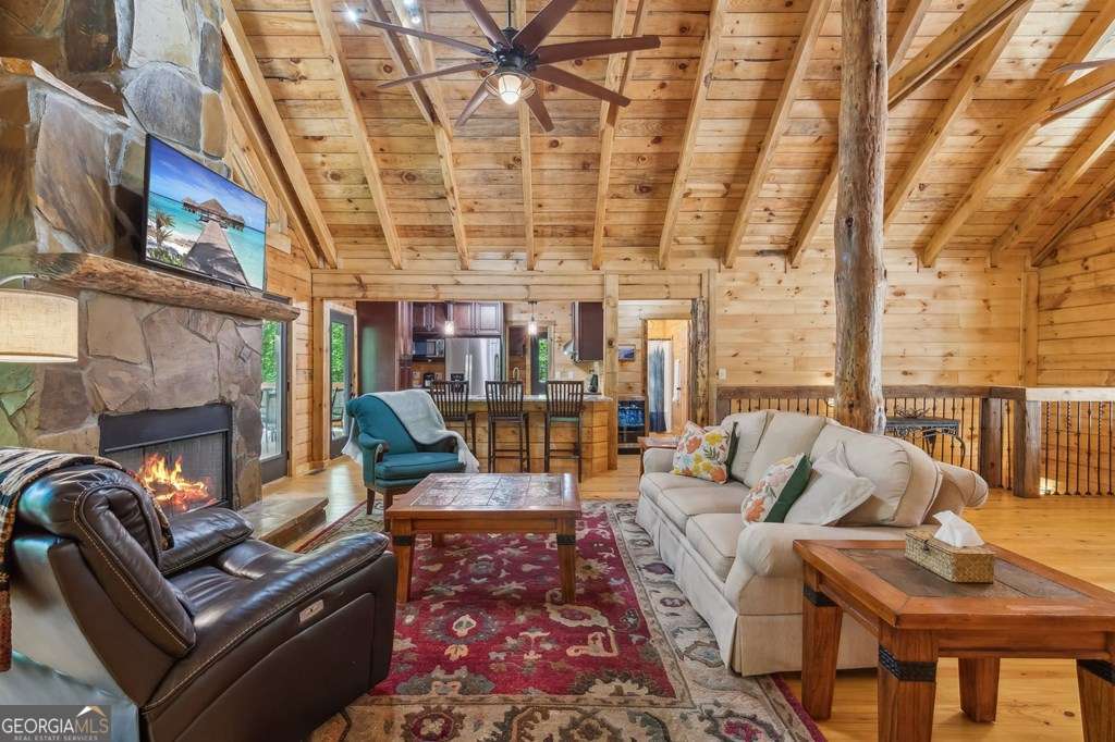 245 Timberwalk Drive, Unit 16 Ellijay, GA 30540 - Photo 11 of 56 a living room with furniture and a fireplace