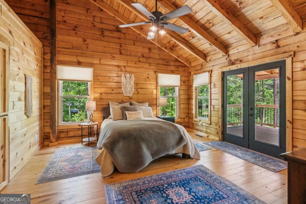 245 Timberwalk Drive, Unit 16 Ellijay, GA 30540 - Photo 23 of 56 a bed sitting in a bedroom next to a window